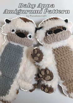 two crocheted stuffed animals are sitting next to each other with paws on them