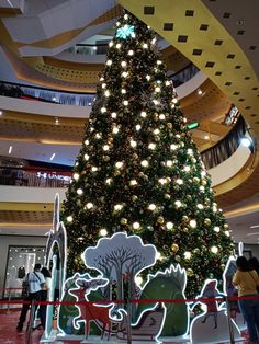 a large christmas tree in the middle of a mall