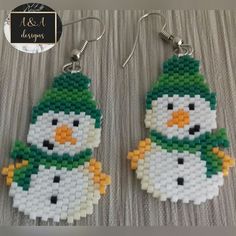 a pair of snowman earrings made out of legos