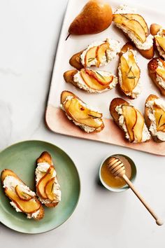 sliced peaches and goat cheese on toasted bread with honey in small dishes next to them