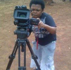 a woman standing in front of a camera