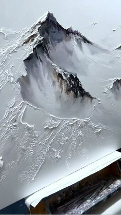 an airplane is flying over the mountains covered in snow and ice as it flies through the air