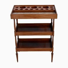 a wooden table with three shelves and two cups on each shelf, against a white background