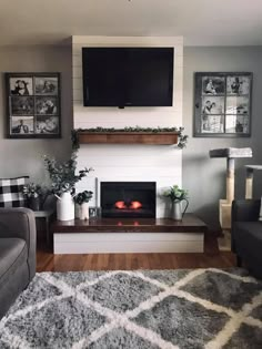 a living room with a tv above the fireplace