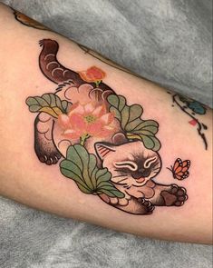 a cat with flowers on it's arm