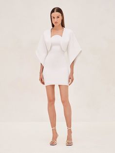 Indulge in luxury and elevate your wardrobe with the Russie Capelet. This elegant garment exudes sophistication, with its sweeping cape-like sleeves and poised neckline that beautifully accentuates the décolletage. It can be worn as a statement piece with the Giasa Mini Dress for a touch of mystery, or layered with the Kamali Midi Dress for a refined and enigmatic look. Model wears XS. Flower Skirt, Skirt Jumpsuit, Jacket Tops, Outfit Of The Day, Jumpsuit Romper, Ready To Wear, Midi Dress, Mini Dress, Luxury Fashion