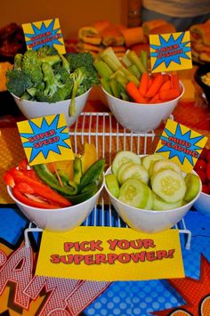 a table topped with bowls of veggies next to a sign that says pick your super power