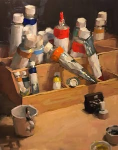 an oil painting of some bottles in a box on a table with other items around it