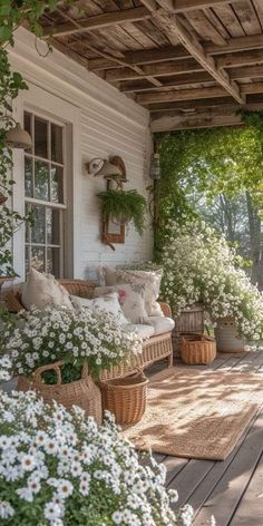 a porch covered in lots of flowers and plants