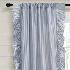 a blue and white striped curtain hanging in front of a window