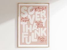 a pink and white poster hanging on the wall