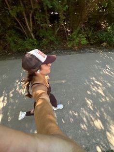 a woman is taking a selfie with her cell phone while walking down the street