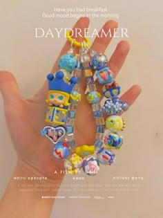 a hand holding a bunch of beads in it's palm with the words daydreamer on it