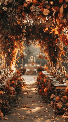 an outdoor dining area with tables and chairs covered in leaves, candles and flowers on the table