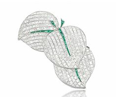 A RARE DIAMOND AND EMERALD BROOCH, BY VAN CLEEF & ARPELS   Designed as three overlapping calibré-cut diamond leaves, of curving outline with similarly cut emerald spine and stem detail, 1937, French marks for platinum and gold, 6.5cm long, with maker's case  Signed Van Cleef & Arpels and no.46036 Emerald Brooch, London In December, Elegant Life, Rare Diamond, Van Cleef And Arpels Jewelry, Jewelry Illustration, Van Cleef And Arpels, Jewelry Auction, Leaf Jewelry