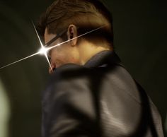 a man with glasses and a black jacket is staring at the light coming through his eyes