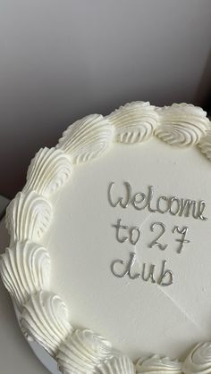 a white cake with the words welcome to 2 / 4 club on it's side