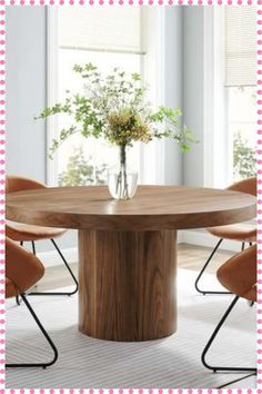 a round wooden table with four chairs around it and a vase on the table top