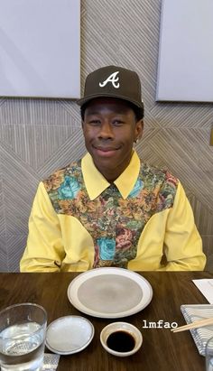 a man sitting at a table in front of a plate