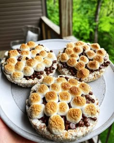 three desserts sitting on top of a white plate