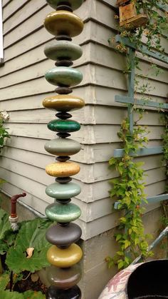 a tall stack of rocks sitting next to a building