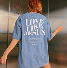 "Embrace the warmth of faith with our \"Love Like Jesus\" Christian shirt. This cozy garment serves as a daily reminder to embody the compassion and kindness exemplified by Jesus. Featuring a timeless verse, this shirt encourages you to carry the message of love wherever you go, wrapping you in the comforting embrace of both scripture and style. Comfort Colors introduces its garment-dyed t-shirt; a fully customizable tee made 100% with ring-spun cotton. The soft-washed, garment-dyed fabric bring Jesus Apparel, John 13 34, Love Like Jesus, Bible Verse Shirt, Aesthetic Shirt, Shirt Aesthetic, Jesus Shirt, Religious Shirt, Aesthetic Shirts