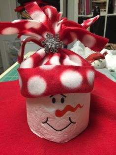 a red and white cup sitting on top of a table