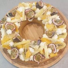 a wooden plate topped with fruit and veggies