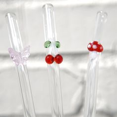 three glass vases filled with different colored candies