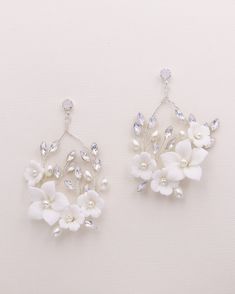 two pairs of white flower and crystal earrings