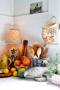 a kitchen counter topped with lots of different types of utensils and food items