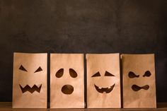 three brown bags with faces drawn on them