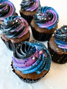 there are many cupcakes that have been decorated with blue and purple icing