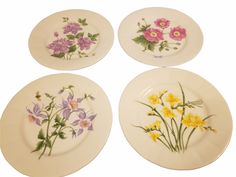 four plates with flowers painted on them