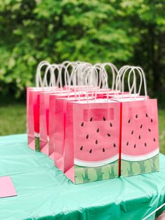 watermelon paper bags sitting on top of a table