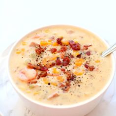 a white bowl filled with soup on top of a plate