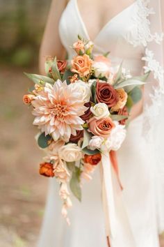 a bride holding a bouquet of flowers in her hand