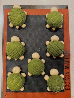 there are some cookies shaped like turtles on a cookie sheet