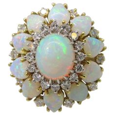 Stunning opals clustered with diamonds in 18 karat yellow gold. Oval center opal with diamond halo is surrounded by pear opals and more diamonds! Opals have beautiful fire. This ring is a size 6. Luxury Yellow Gold Opal Ring With Halo Design, Luxury Brilliant Cut Yellow Gold Opal Ring, Gold Wedding Rings Vintage, Gold Band Wedding Ring, Opal And Diamond Ring, Opal Diamond Ring, Art Ring, Wedding Rings Vintage, Fabulous Jewelry