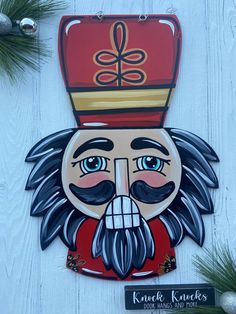 a wooden sign with a man's face painted on it