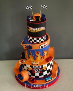 a three tiered cake with cars on it