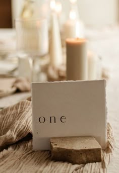 a table setting with candles and napkins on it