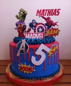 the birthday cake is decorated with superhero characters