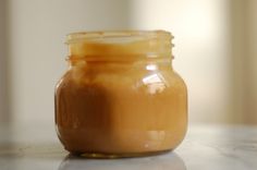 a jar filled with liquid sitting on top of a counter