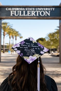 a person wearing a graduation cap that reads, california state university fullerton on it