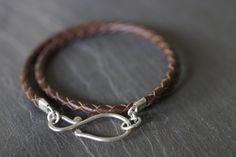 Simple braided brown leather and sterling silver double wrap bracelet. Hand-crafted hook measures 3cm x 1.5cm. Approx 6cm diameter Double Wrap Leather Bracelet, Everyday Silver Leather Braided Bracelet, Silver Leather Braided Bracelet, Brown Hand-strung Wrap Bracelet, Casual Brown Leather Bracelet, Hand Wrapped, Bracelets Hippie, Double Wrap Bracelet, Hippie Bracelets, Wrist Cuffs