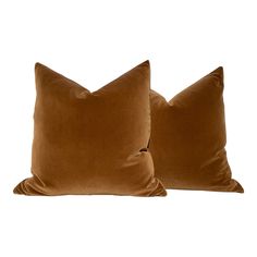 two brown velvet pillows sitting next to each other