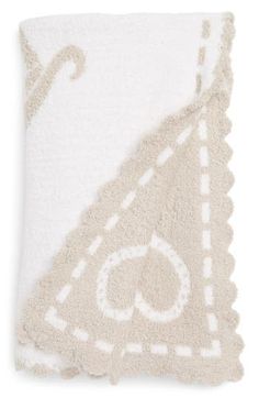 a white towel with an embroidered design on it