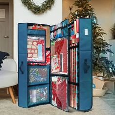 an open blue suitcase sitting on top of a carpeted floor next to a christmas tree