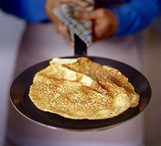 two pancakes on a pan with butter and syrup